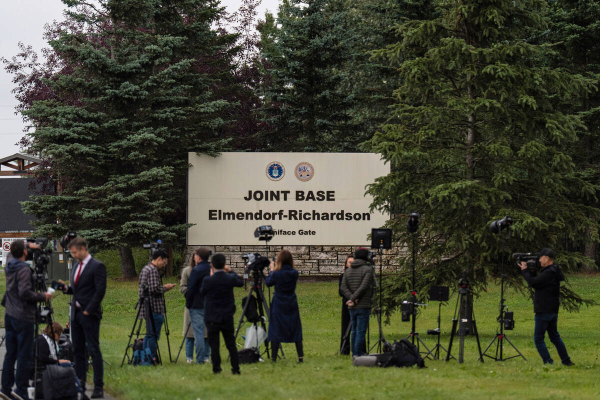 Members of the media stand outside Joint Base Elmendorf-Richardson in Anchorage, Alaska, Thursd ...