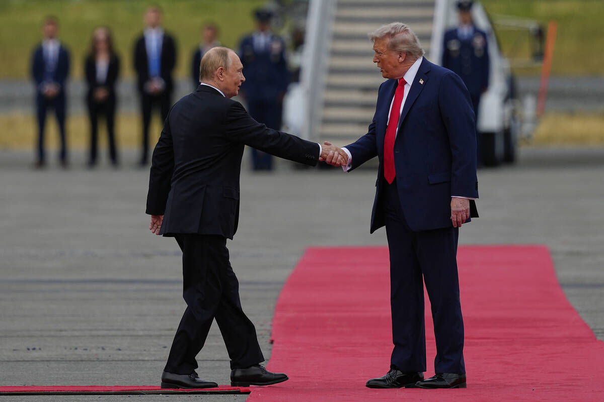 President Donald Trump greets Russia's President Vladimir Putin Friday, Aug. 15, 2025, at Joint ...