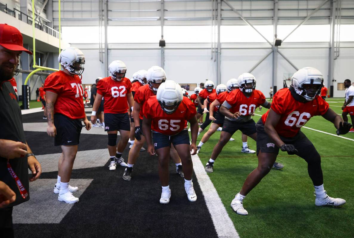 UNLV offensive lineman Ace Robinson (65) warms up with teammates during football practice at th ...