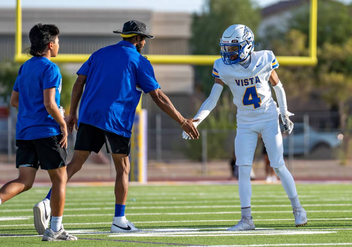 Sierra Vista’s Julian Guzman (4) high-fives his coach during Friday night’s game ...