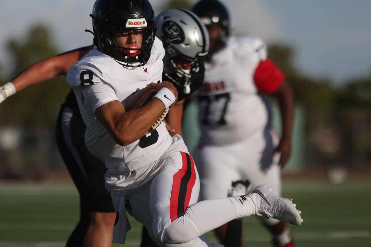 Las Vegas quarterback Tanner Vibabul (8) scrambles past Palo Verde's Kyle Johnson (8) in the fi ...
