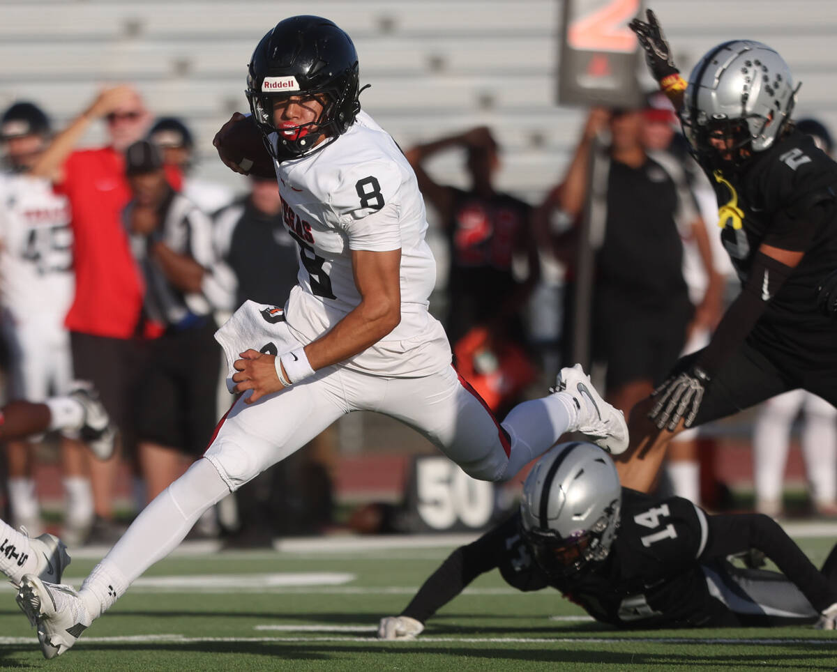 Las Vegas quarterback Tanner Vibabul (8) scrambles past Palo Verde's X'Zavier McZeal (14) in th ...