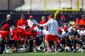 UNLV head coach Dan Mullen speaks with concern to his players and coaches during football pract ...