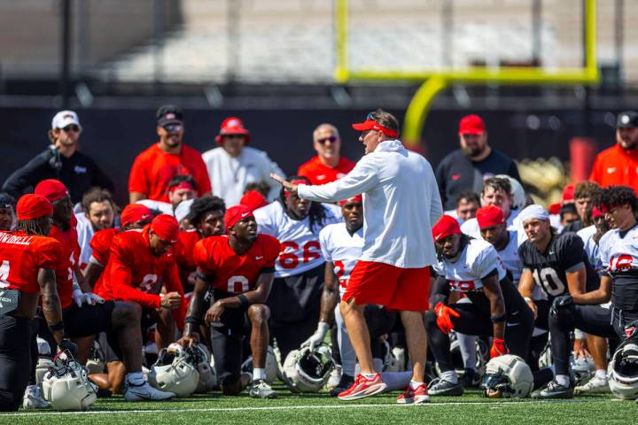 UNLV head coach Dan Mullen speaks with concern to his players and coaches during football pract ...