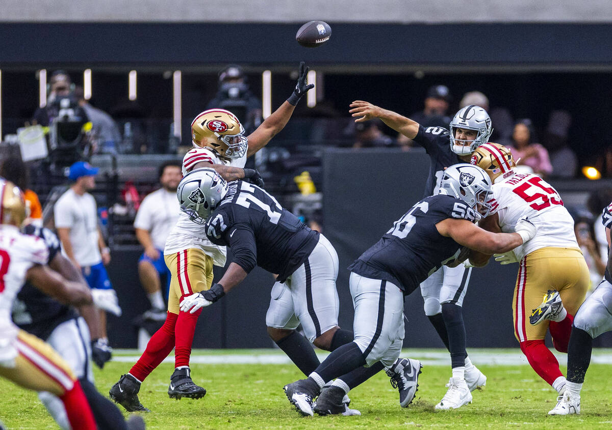 Raiders quarterback Aidan O'Connell (12) gets off a pass against the San Francisco 49ers during ...