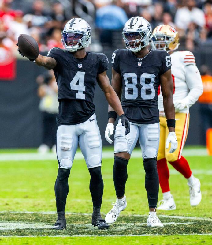 Raiders wide receiver Shedrick Jackson (4) signals another first down with tight end Justin Sho ...