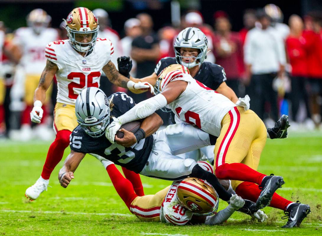 Raiders running back Chris Collier (35) battles for another first down while taken down by San ...