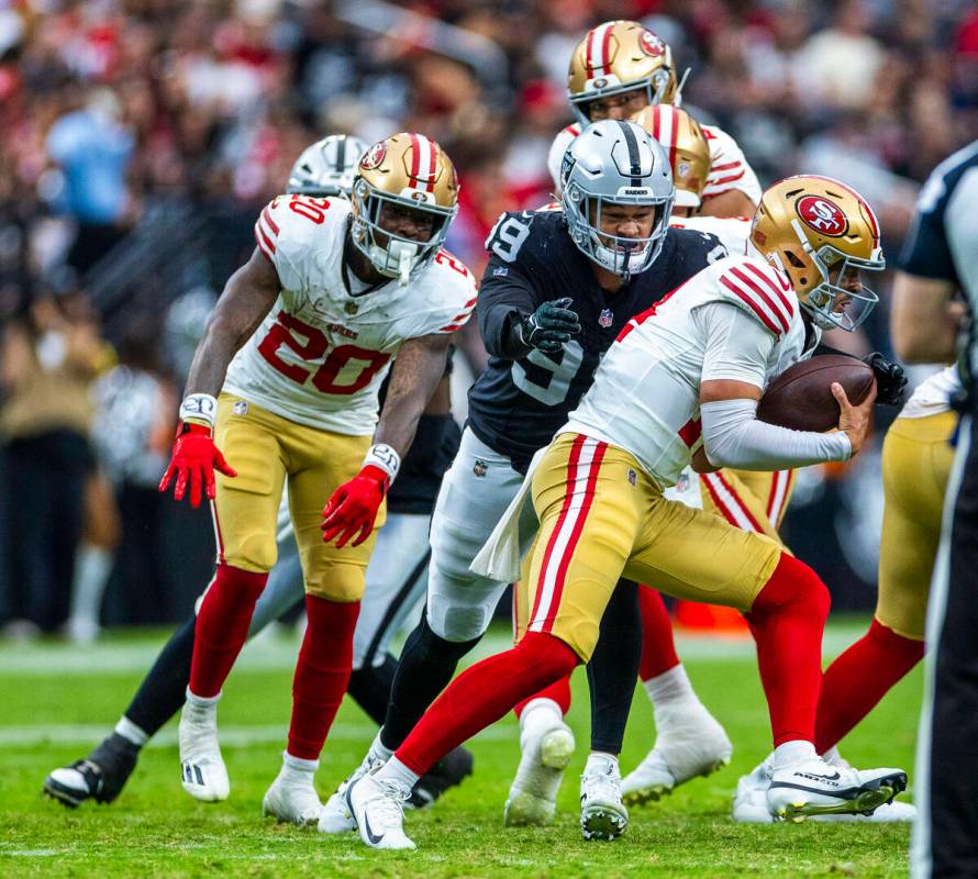 San Francisco 49ers quarterback Carter Bradley (14) sacked by Raiders defensive end Andre Carte ...