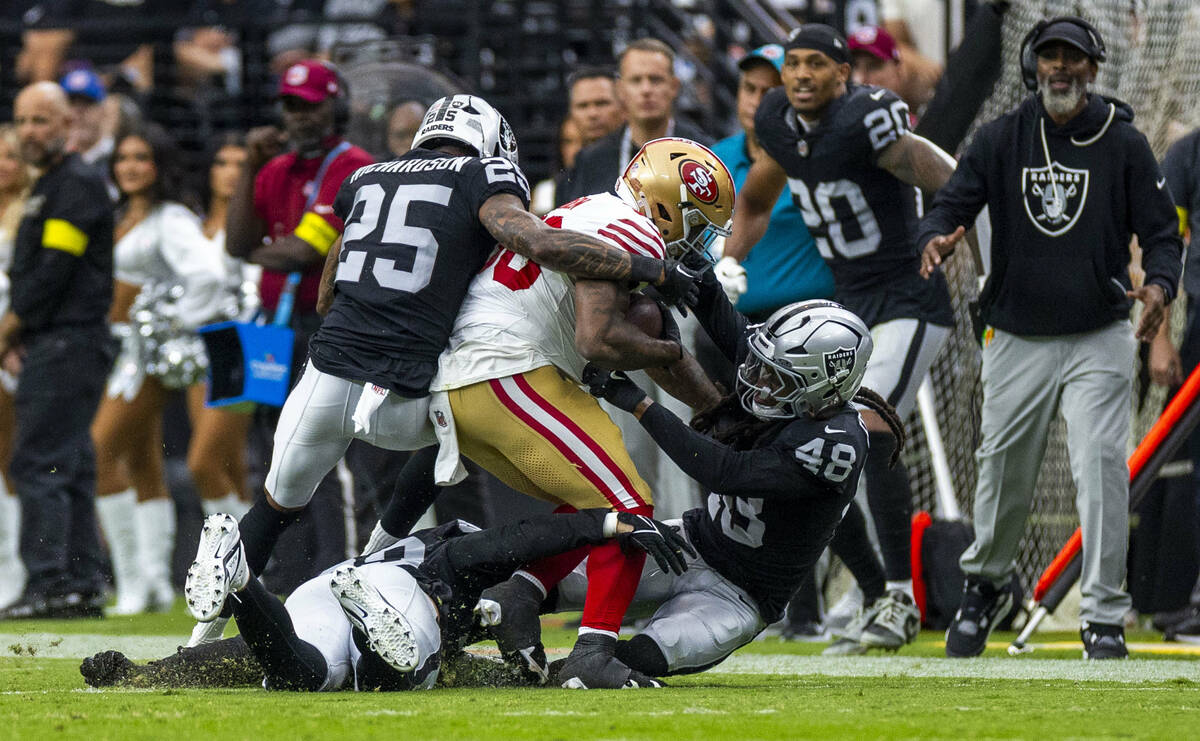 Raiders safety Terrell Edmunds (48) and cornerback Decamerion Richardson (25) team up to tackle ...