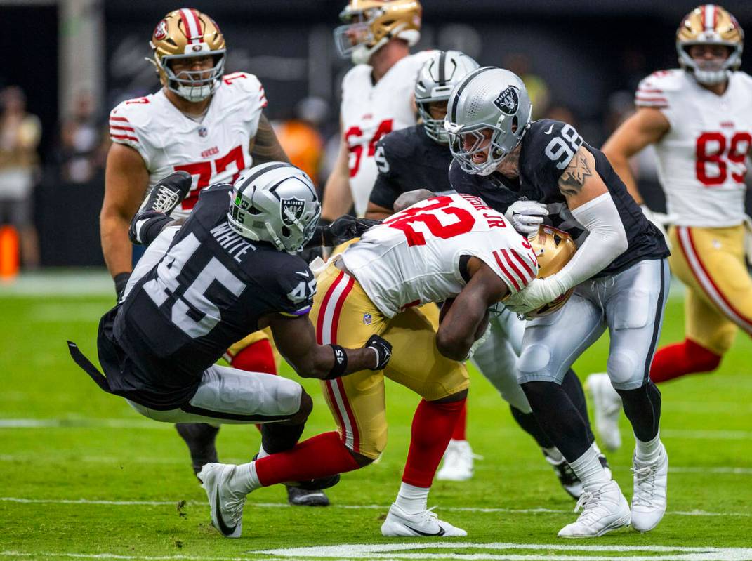 San Francisco 49ers running back Patrick Taylor Jr. (32) is tackled by Raiders linebacker Devin ...