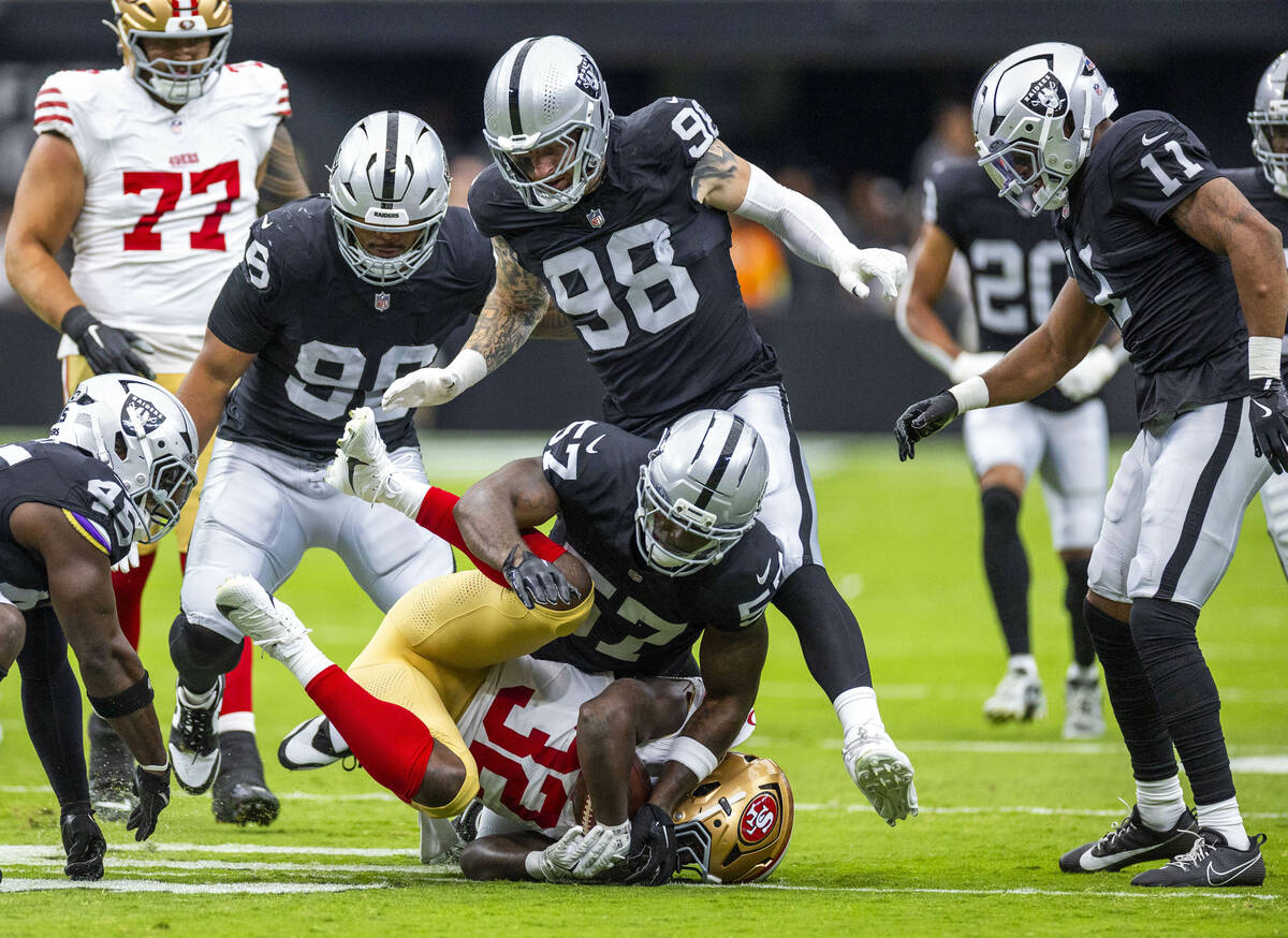 San Francisco 49ers running back Patrick Taylor Jr. (32) is tackled by Raiders linebacker Germa ...