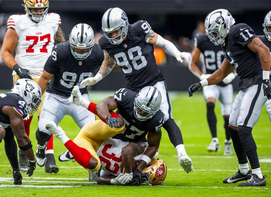San Francisco 49ers running back Patrick Taylor Jr. (32) is tackled by Raiders linebacker Germa ...