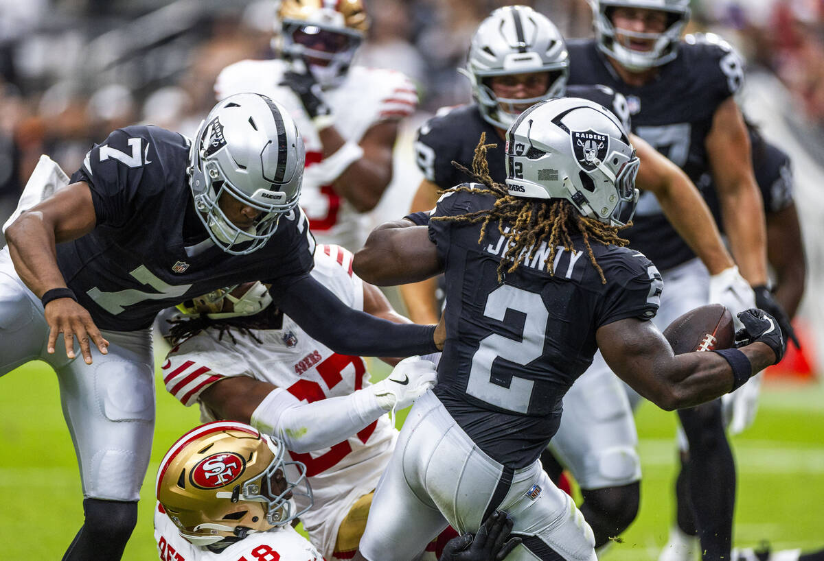 Raiders running back Ashton Jeanty (2) scores after colliding with San Francisco 49ers safety J ...