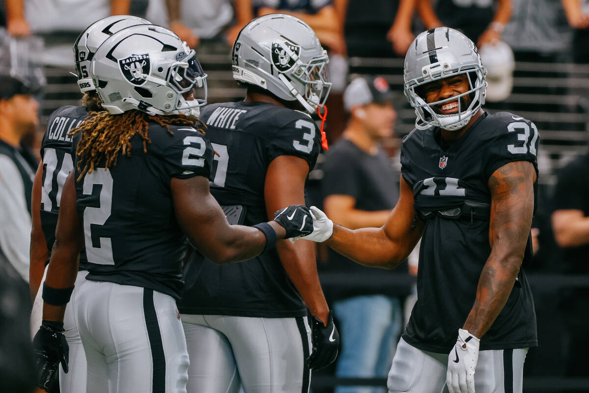 Raiders running back Ashton Jeanty (2), Raiders running back Zamir White (3) and Raiders runnin ...