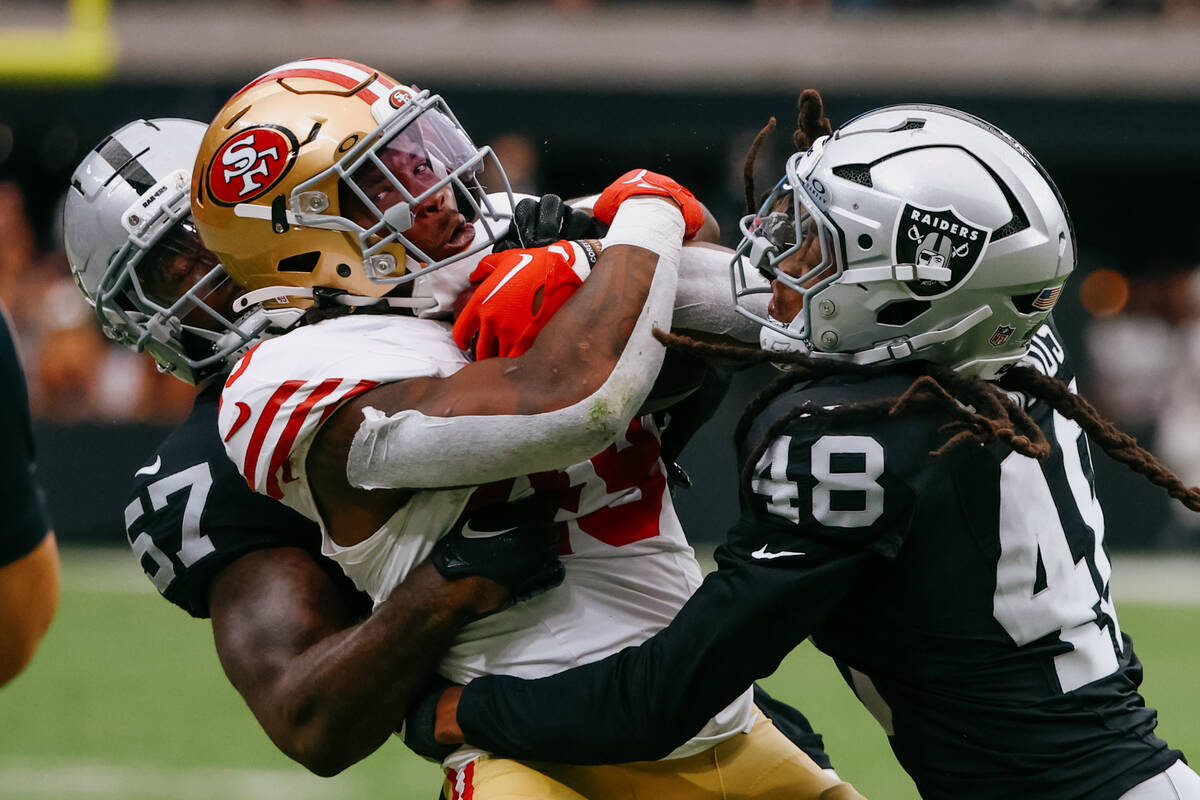 Raiders linebacker Germaine Pratt (57) and Raiders safety Terrell Edmunds (48) tackle San Franc ...