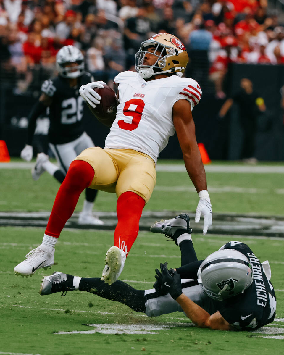 Raiders linebacker Tommy Eichenberg (44) trips up San Francisco 49ers tight end Brayden Willis ...