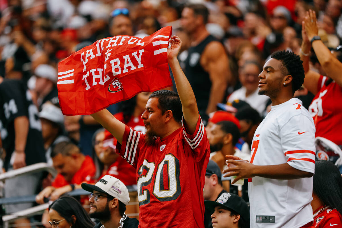 A San Francisco fan celebrates a score by the 49ers during the first half of the game on Saturd ...