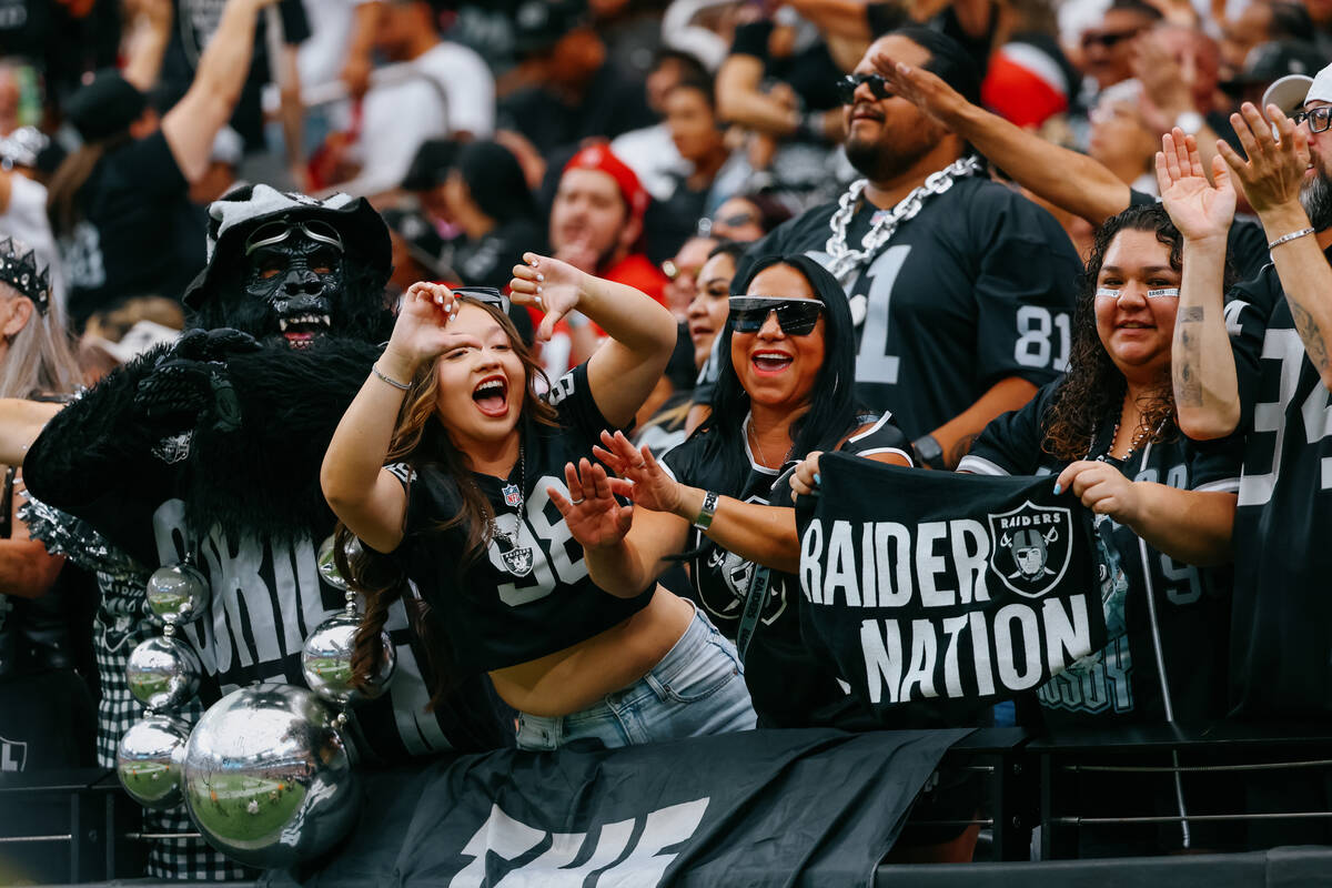 Raiders fans celebrate a failed field goal attempt by the 49ers during the first half of the ga ...