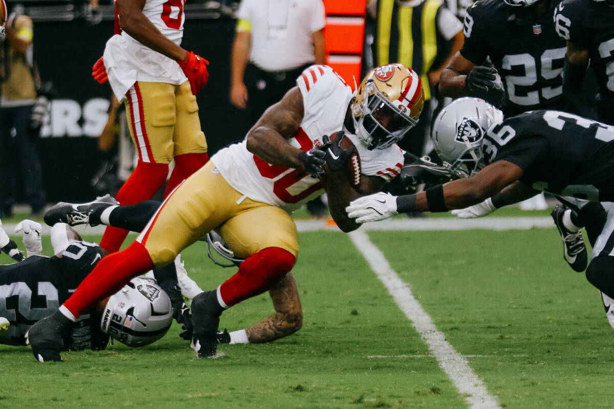 San Francisco 49ers running back Ke'Shawn Vaughn (30) reaches for more yardage during the first ...