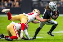 Raiders running back Ashton Jeanty (2) looks to shake off a tackle attempt by San Francisco 49e ...
