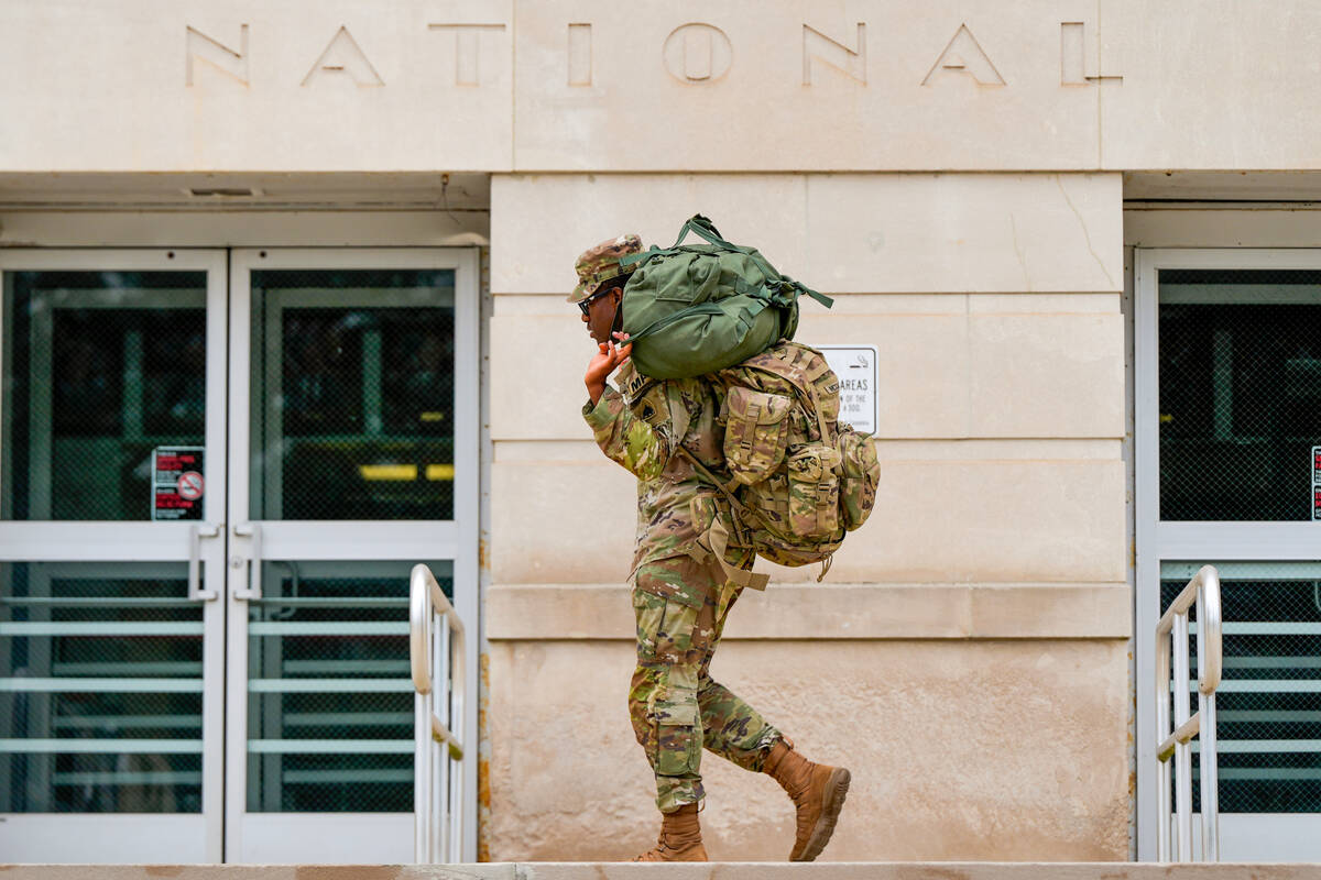 A member of the District of Columbia National Guard arrives at the District of Columbia Nationa ...
