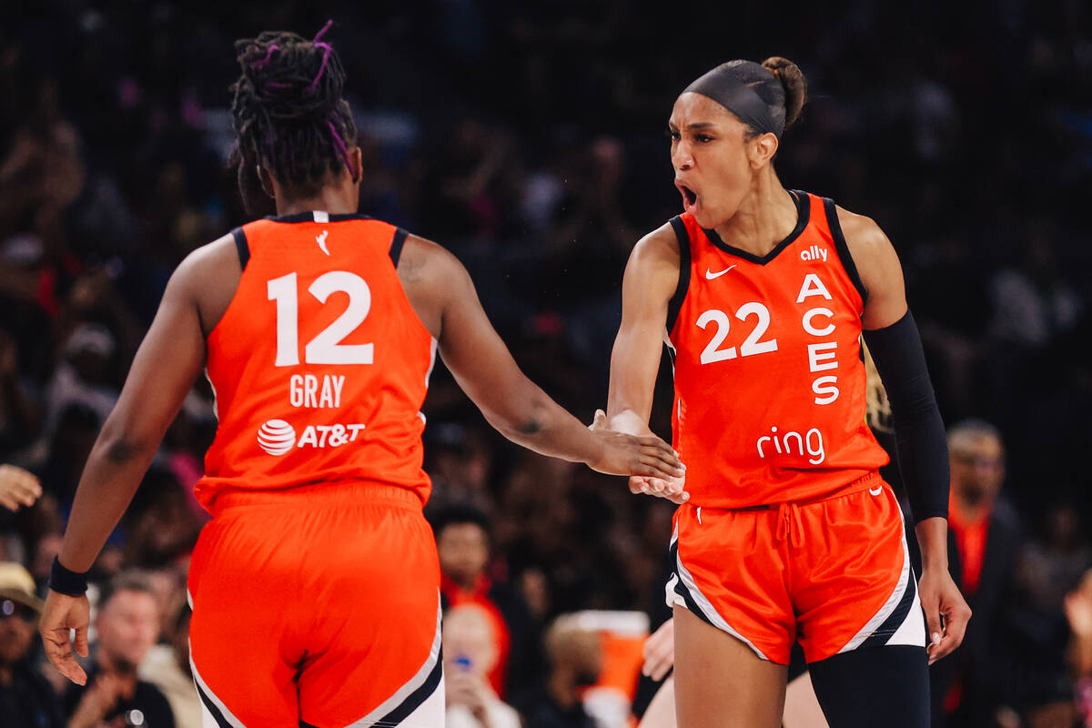 Aces guard Chelsea Gray (12) high-fives Aces center A'ja Wilson (22) during a WNBA basketball g ...