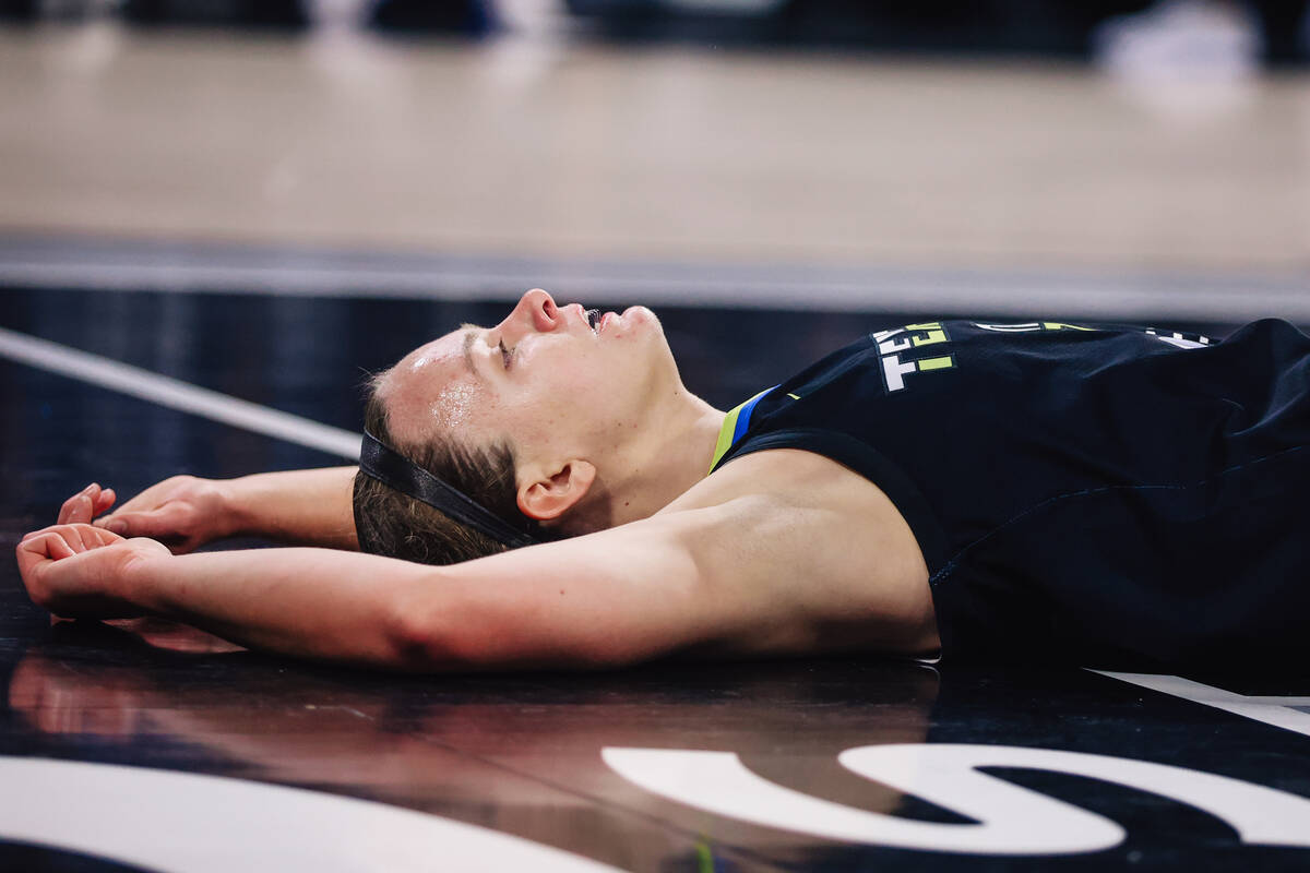 Dallas Wings guard Grace Berger lies on the floor during a WNBA basketball game between the Ace ...
