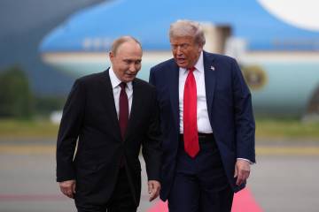 U.S. President Donald Trump, right, walks with Russian President Vladimir Putin as they arrive ...