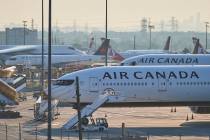 Air Canada planes sit on the runway at Pearson International Airport as flight attendants go on ...