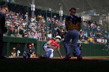 Las Vegas, Nev.'s Griffin Vargas, center, slides into home to win a baseball game against ...