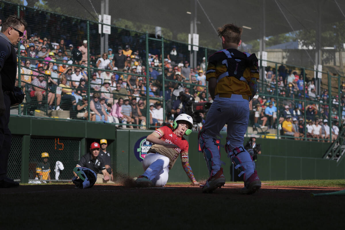 Las Vegas, Nev.'s Griffin Vargas, center, slides into home to win a baseball game against ...