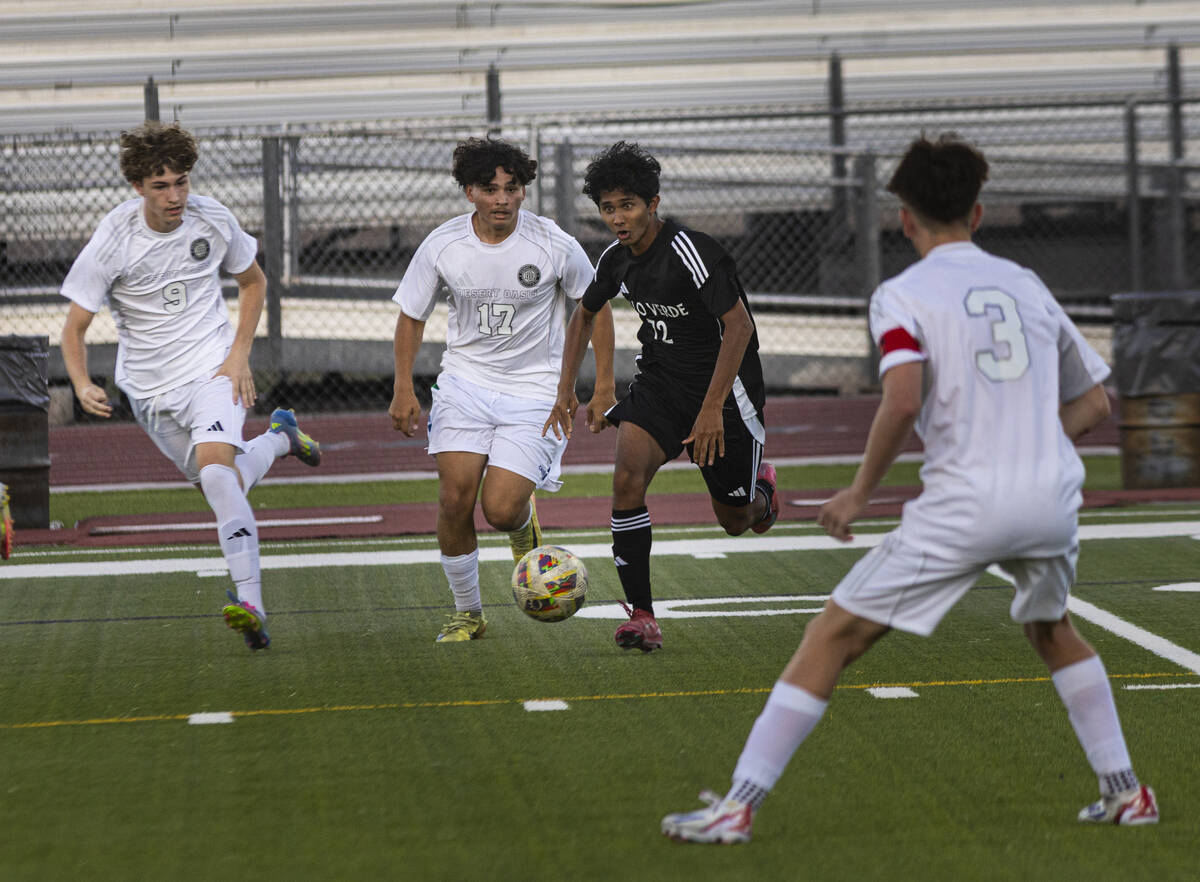Palo Verde's Haydn Rodrigues (72) tries to get the ball around Desert Oasis' lan Gonzalez (17) ...