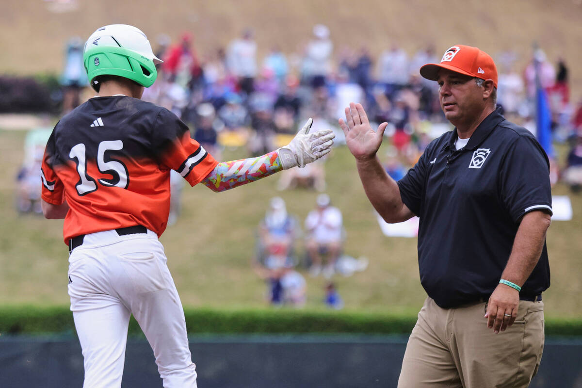 Fairfield, Conn.'s Tommy D'Amura celebrates his home run with position coach P.J. Kippenhan du ...