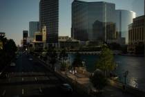 People walk along the Las Vegas Strip, Friday, Aug. 8, 2025, in Las Vegas. (AP Photo/John Locher)