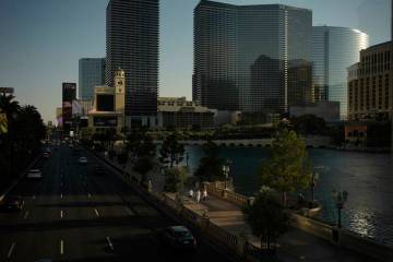 People walk along the Las Vegas Strip, Friday, Aug. 8, 2025, in Las Vegas. (AP Photo/John Locher)