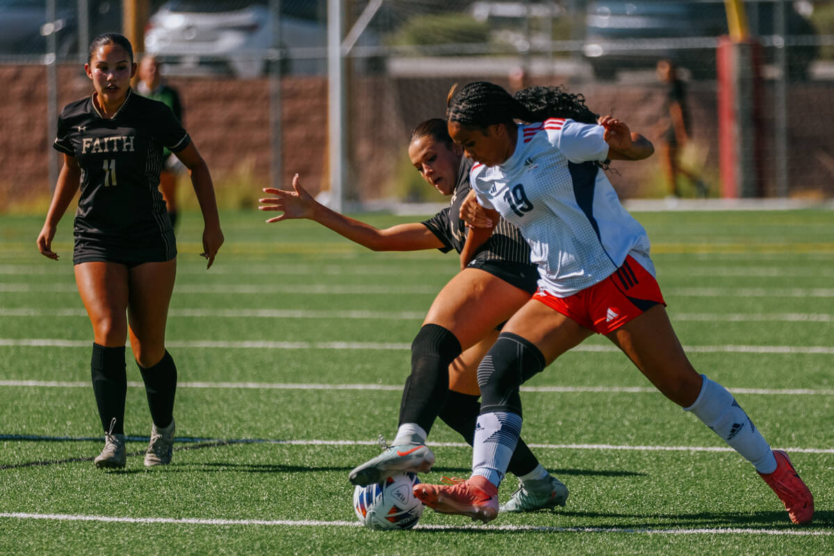 Faith Lutheran defender Posie Armstrong (5) and Liberty forward Madalynn Smith (19) spar for co ...