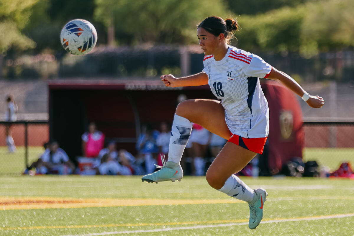 Liberty midfielder Kaimiinameapono Wills (18) leaps up to catch the ball with her feet during a ...