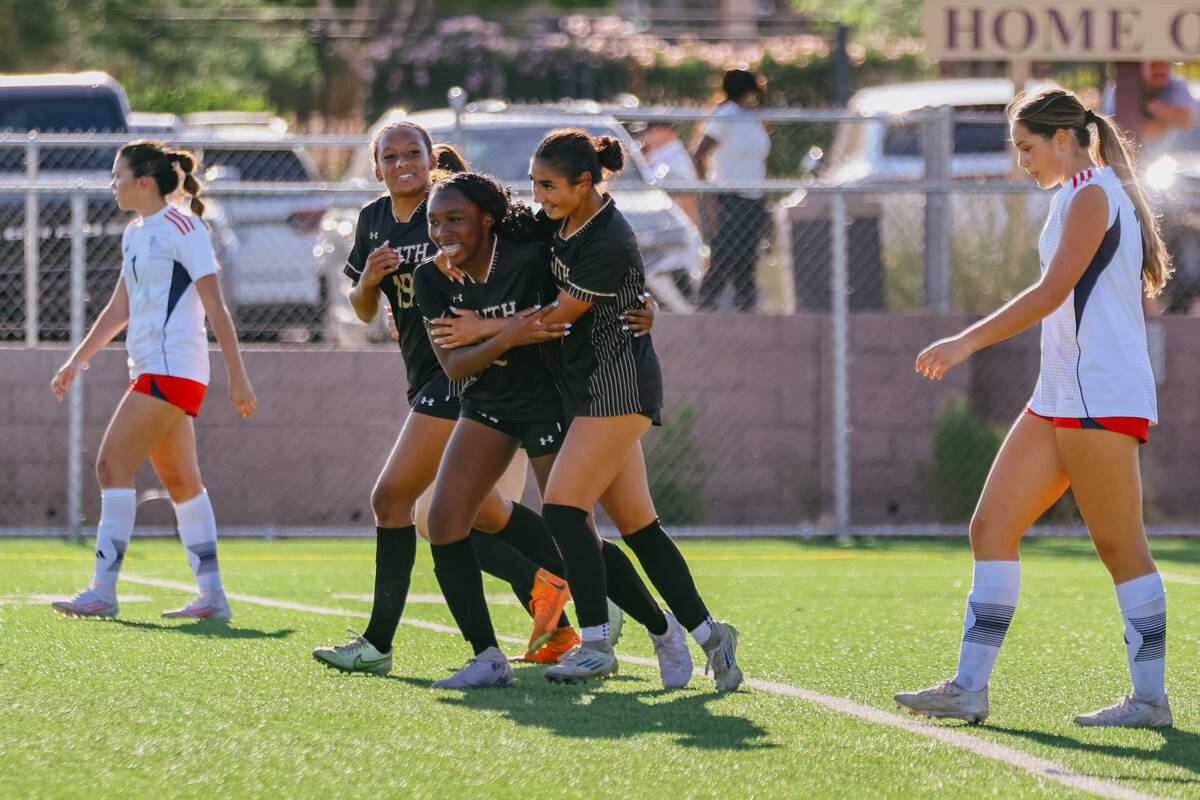 Teammates celebrate Faith Lutheran’s Brianna Lee (19), left, after her goal, the Crusaders’ ...
