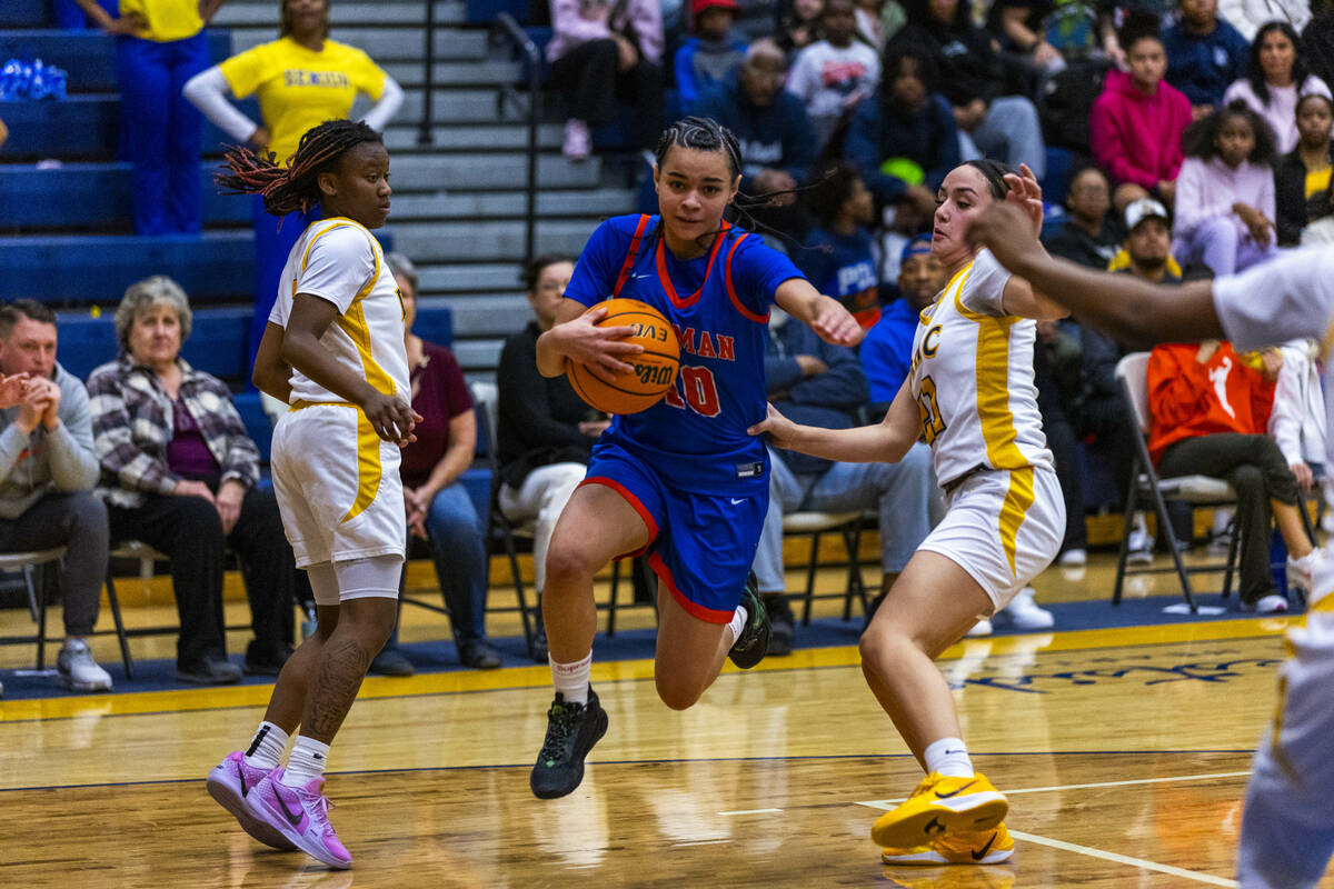 Bishop Gorman guard Aaliah Spaight (10) splits the defense of Democracy Prep guard Bray'ana Mil ...