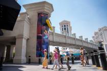 Pedestrians pass by the elevator towers along The Strip on Aug. 5, 2025 in Las Vegas. (Kara Gil ...