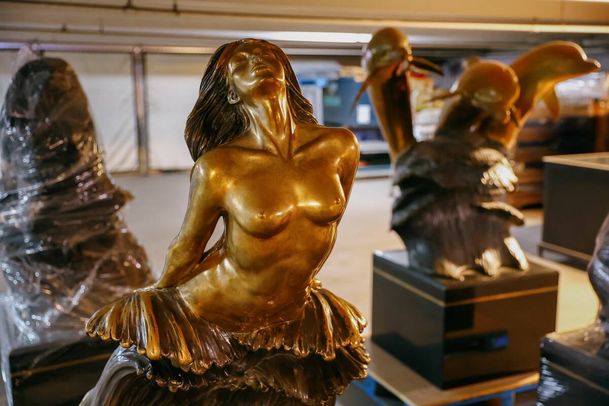 Bronze mermaid and dolphin statues from the now-defunct Mirage sit in storage on Tuesday, Aug. ...