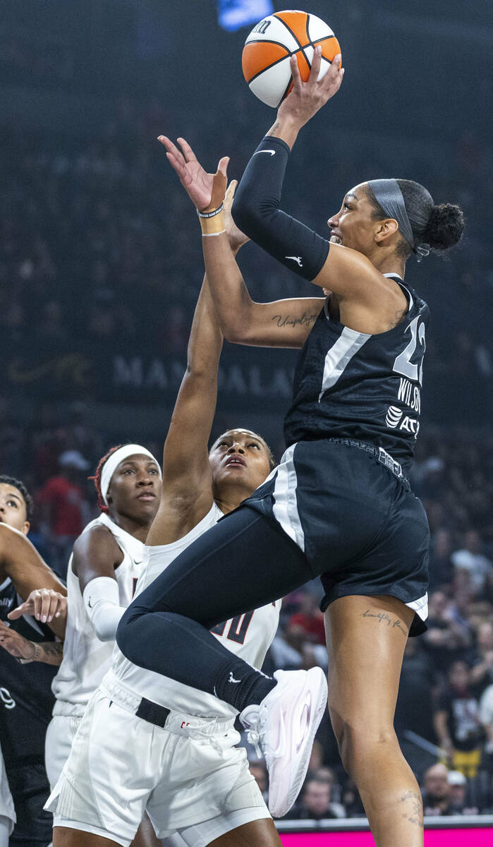 Aces center A'ja Wilson (22) elevates to shoot over Atlanta Dream forward Naz Hillman (00) duri ...