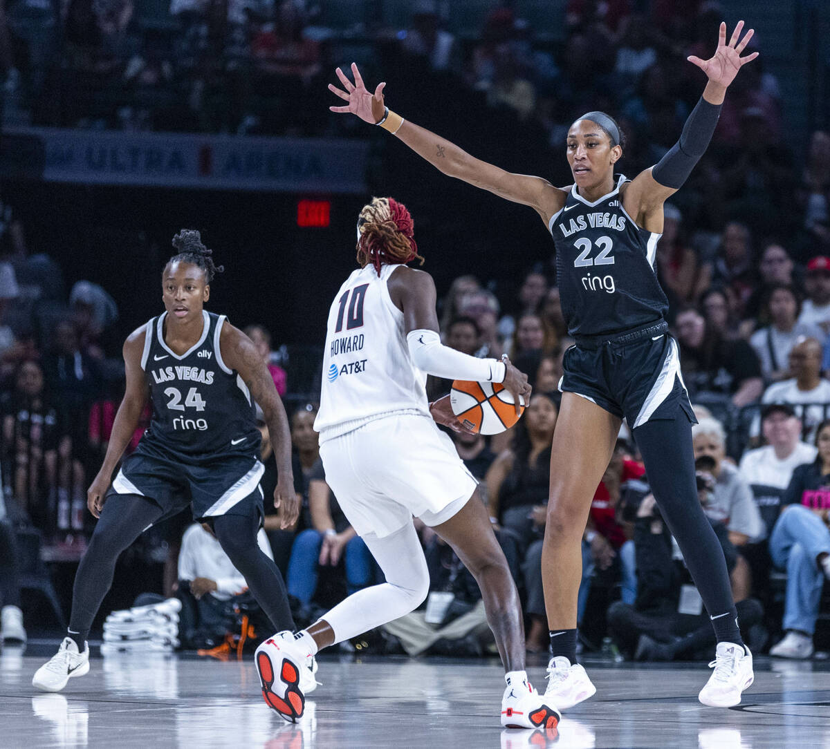 Atlanta Dream forward Nia Coffey (12) looks to pass around Aces center A'ja Wilson (22) during ...