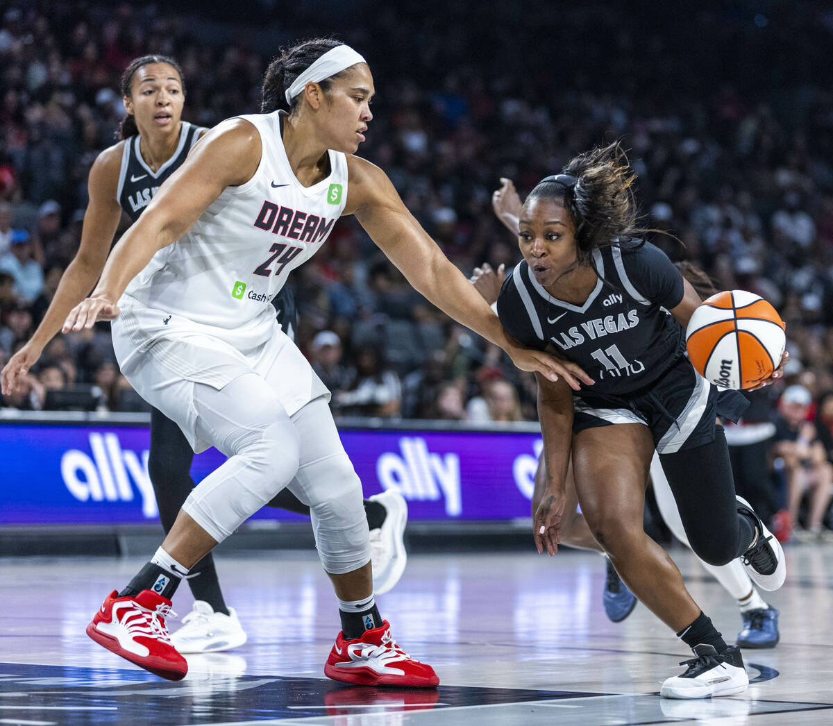 Aces guard Dana Evans (11) looks to drive the lane past Atlanta Dream forward Brionna Jones (24 ...