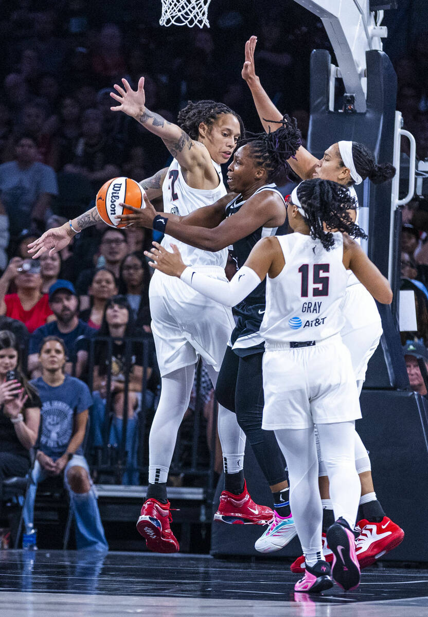 Aces guard Chelsea Gray (12) maneuvers between Atlanta Dream center Brittney Griner (42), forwa ...