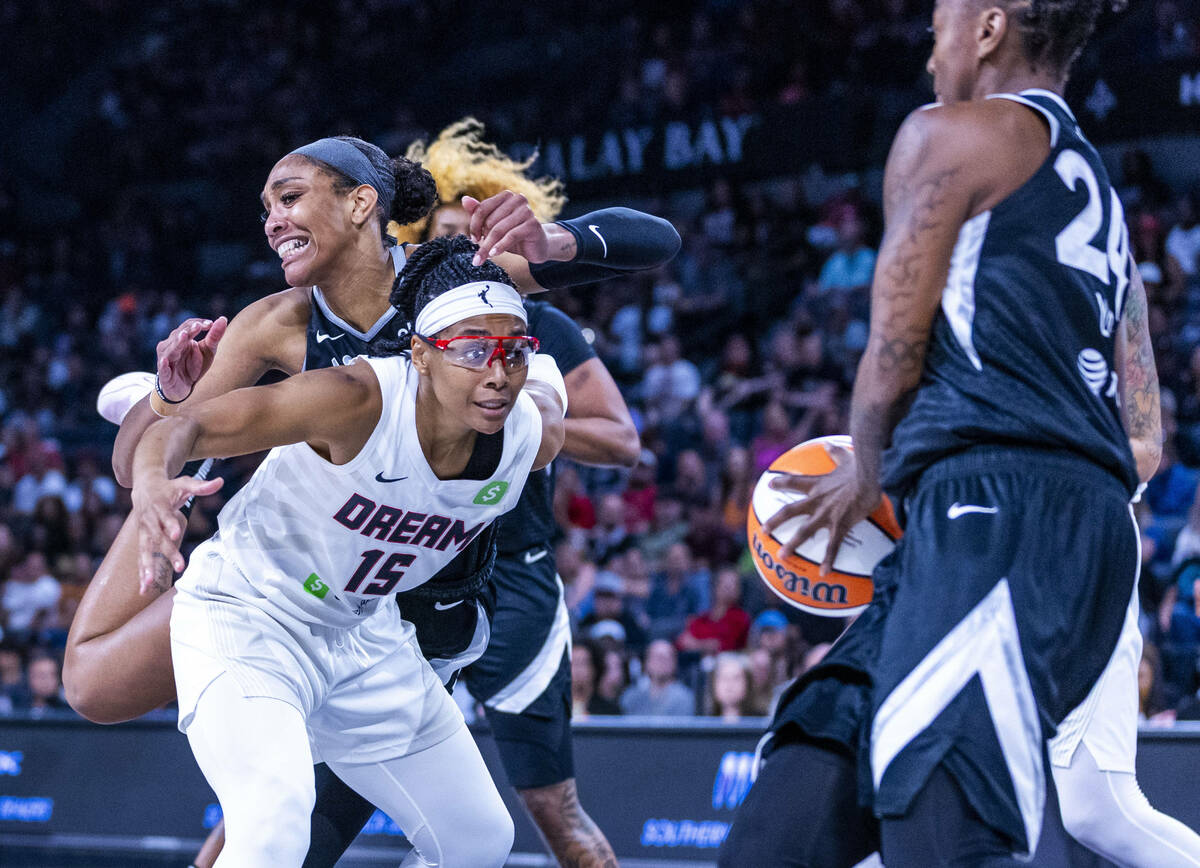Aces center A'ja Wilson (22) is pushed out by Atlanta Dream guard Allisha Gray (15) Aces guard ...