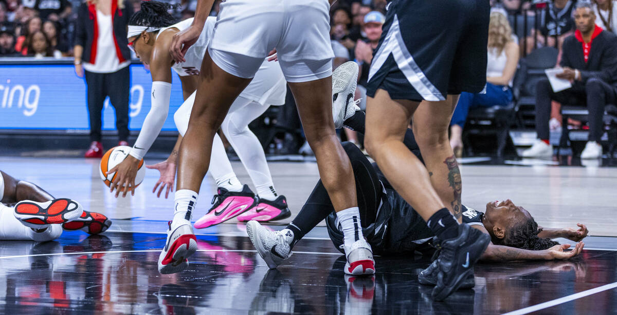 Aces guard Jewell Loyd (24) goes down to the court hard after a collision with Atlanta Dream gu ...