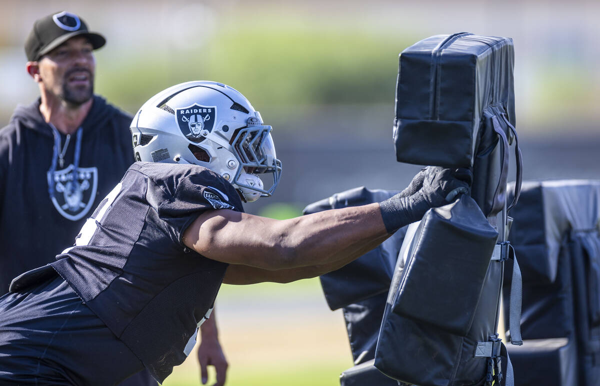 Raiders defensive end Tyree Wilson (9) strikes some pads during a drill at the Intermountain He ...