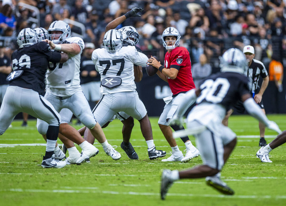 Raiders quarterback Aidan O'Connell (12) looks for a receiver during the first half of a Raider ...