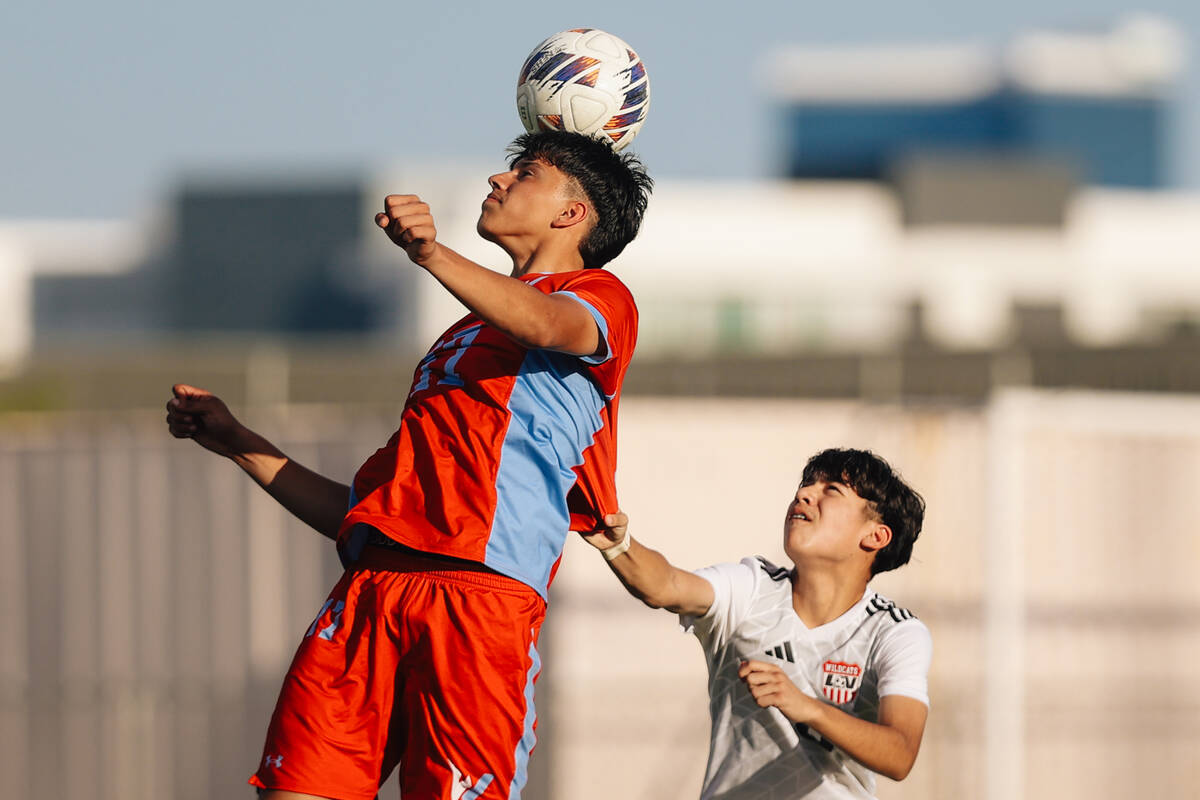 Western striker Jose Luna (17) bumps the ball with his head during a high school boys soccer ga ...